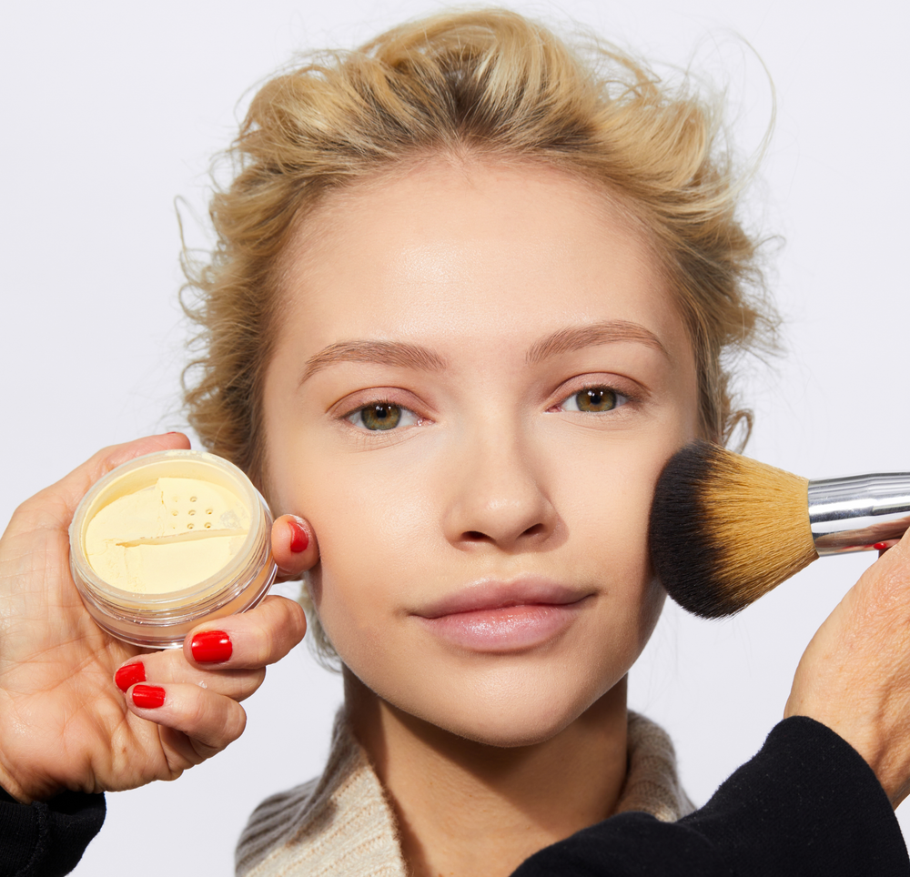 Adelina showing her Soft Matte look as a makeup artist applies Tinted Face Powder from Jones Road Beauty