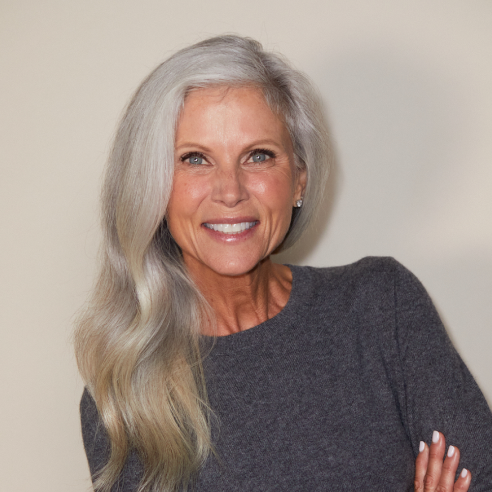 A woman showing off her no makeup makeup look using Jones Road Beauty products