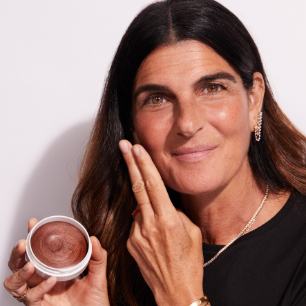 A woman applying Jones Road Beauty's Miracle Balm
