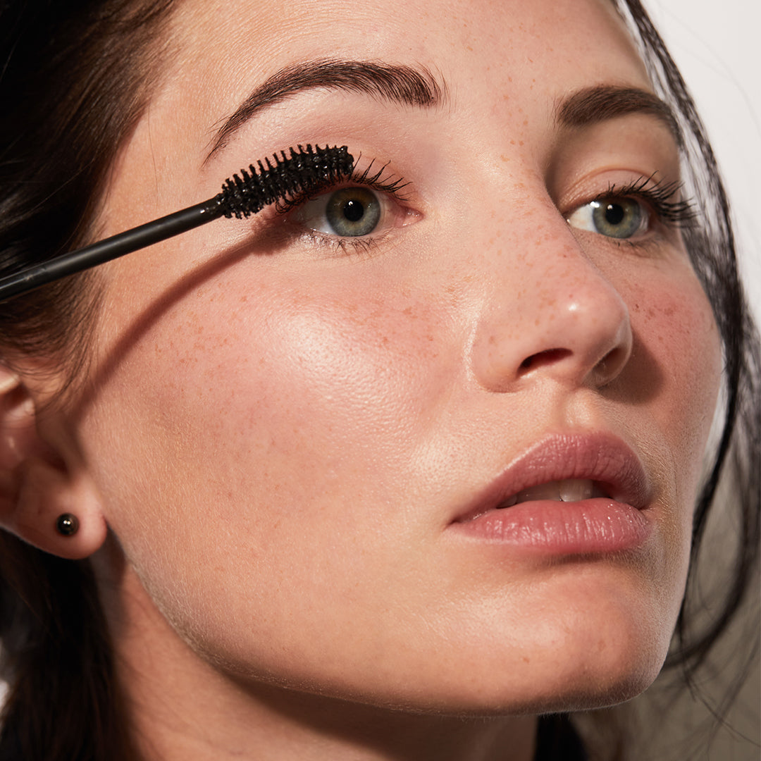 A woman applying The Mascara from Jones Road Beauty